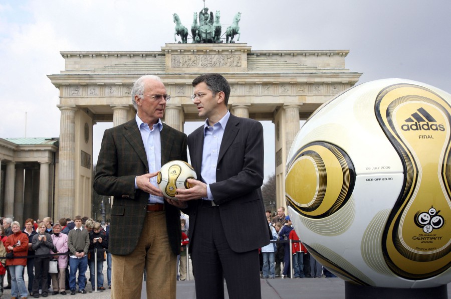  President of the Organising Committee of the 2006 FIFA Football World Cup Franz Beckenbauer (L) and CEO of German sporting goods giant Adidas Herbert Hainer (R) hold the football that will be used in the final of the World Cup, during an unveiling ceremony in front of the Brandenburg Gate in Berlin 18 April 2006.- AFP PIC