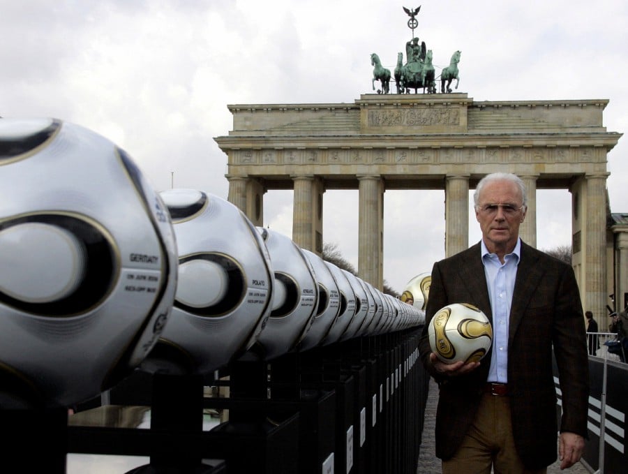Franz Beckenbauer, President of Germany's World Cup organising committee, holds a golden soccer ball during a presentation next to the Brandenburg gate in Berlin, Germany, April 18, 2006. -REUTERS PIC