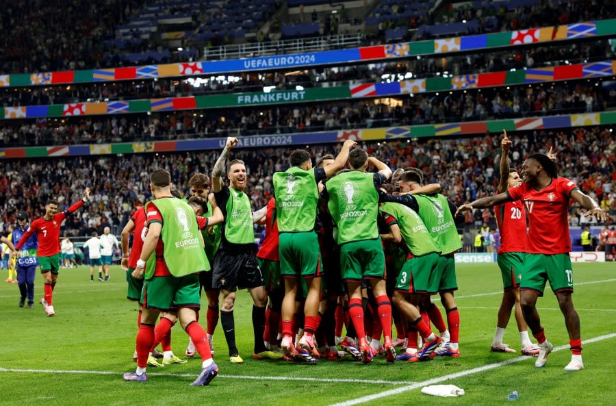 Portugal's Diogo Costa celebrates with teammates after winning the penalty shootout. - REUTERS PIC