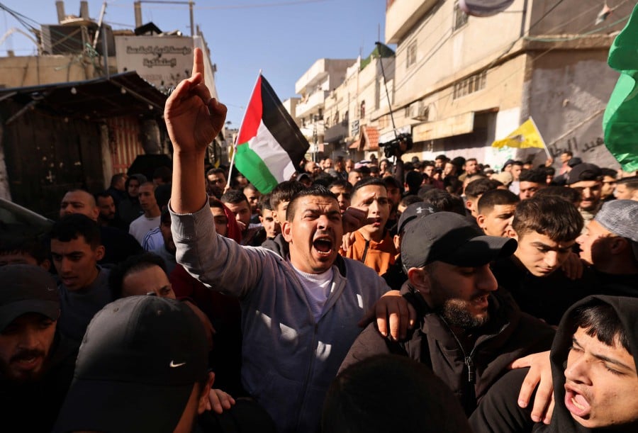 Mourners attend the funeral procession of two men killed in an Israeli army incursion in the al-Fawwar refugee camp, south of Hebron in the occupied West Bank. - AFP PIC