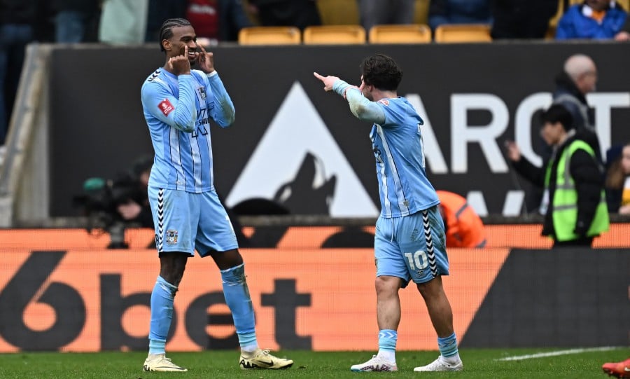 Coventry City's Haji Wright (L) celebrates with Callum O'Hare (R) after scoring their third goal against Wolverhampton at the Molineux stadium in Wolverhampton. - AFP PIC