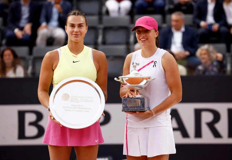 Poland's Iga Swiatek celebrates with the trophy after winning the final match against runners up Belarus' Aryna Sabalenka during the Italian Open in Rome, on May 18. - REUTERS PIC