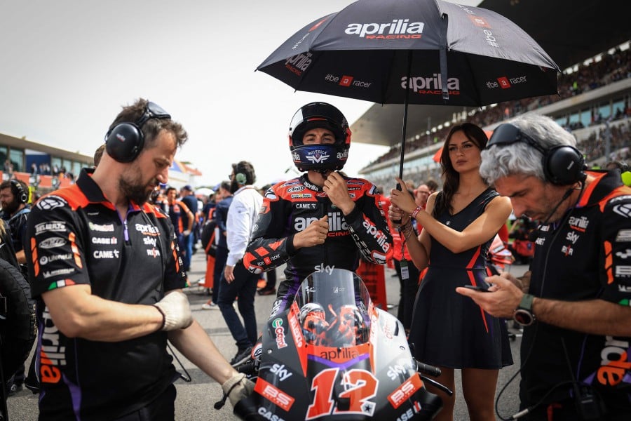 Aprilia Spanish rider Maverick Vinales sits on his bike on the starting grid prior to the MotoGP sprint race of the Portuguese Grand Prix at the Algarve International Circuit in Portimao. - AFP PIC