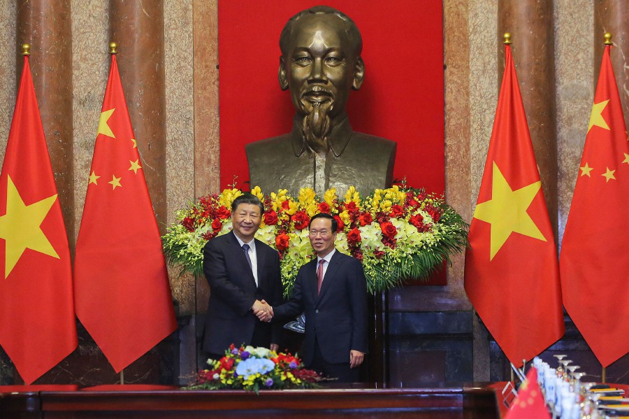 Vietnam's President Vo Van Thuong (R) and China's President Xi Jinping shake hands during a meeting at the Presidential Palace in Hanoi. - AFP PIC