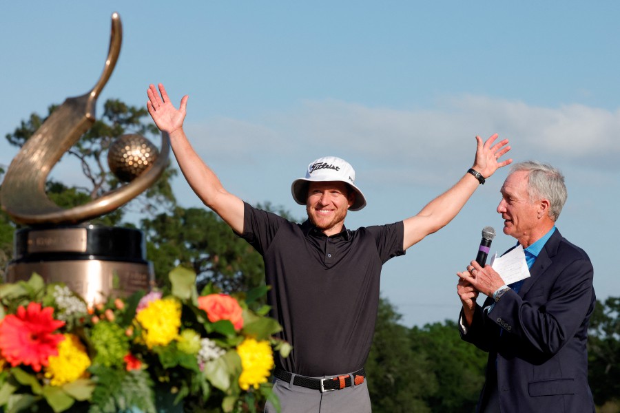 Peter Malnati reacts after being introduced by Copperhead’s member Gary Koch, right, as the winner of the Valspar Championship golf tournament. --REUTERS PIC