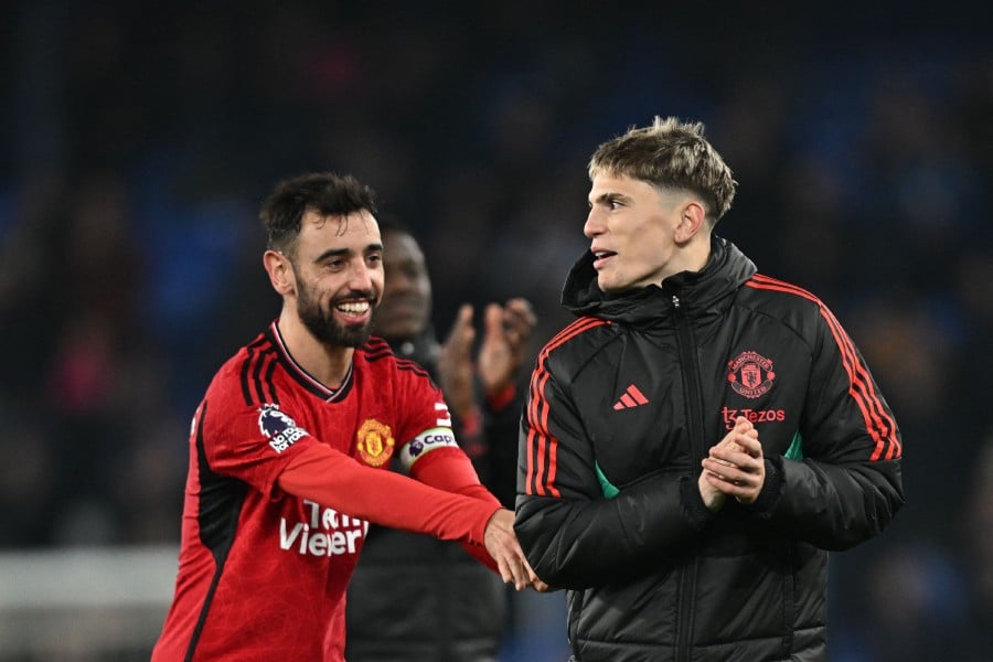 Manchester United's Bruno Fernandes and Alejandro Garnacho celebrate at the end of the English Premier League football match between Everton and Manchester United at Goodison Park in Liverpool. - AFP PIC