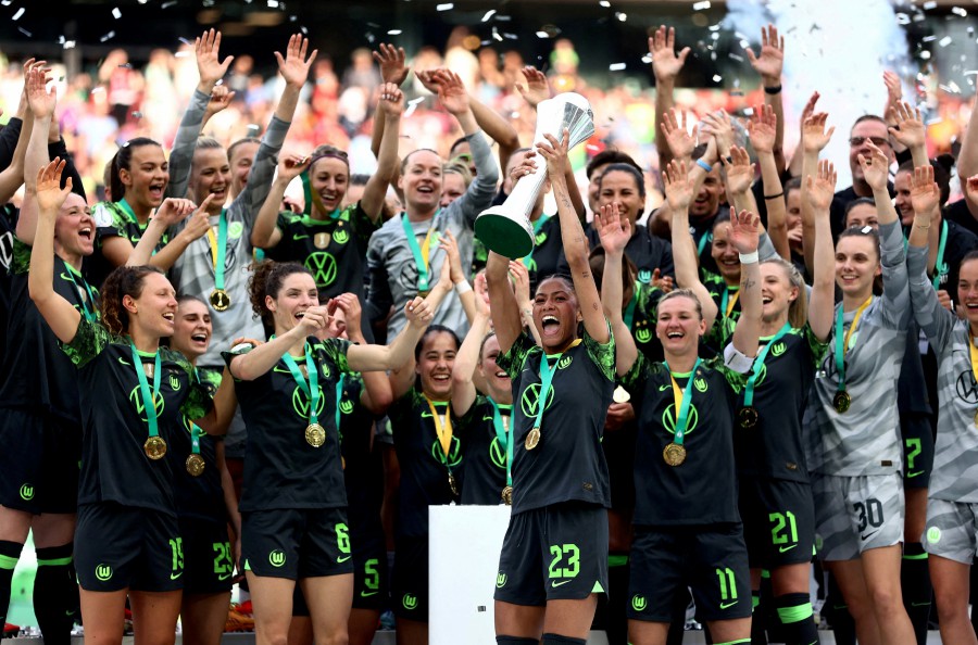 VfL Wolfsburg's Sveindis Jane Jonsdottir celebrates with the trophy and teammates after winning the DFB Cup. - REUTERS PIC