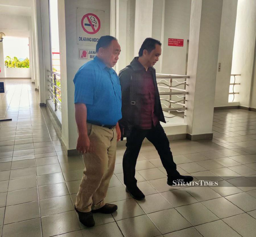 Benjamin Talah (left) arrives at the Special Corruption Court in Labuan ahead of the hearing. -Pic courtesy of MACC