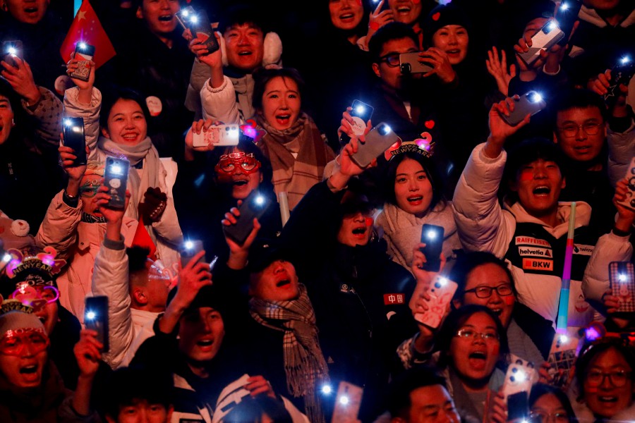 People hold up their phones during the New Year's countdown event at the Shougang Park in Beijing, China. - REUTERS PIC