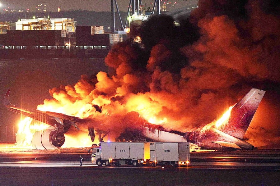 Japan Airlines plane on fire on a runway of Tokyo's Haneda Airport. - AFP PIC