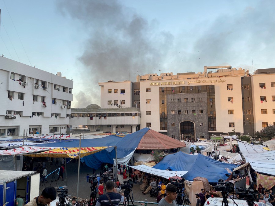Smoke rises as displaced Palestinians take shelter at Al Shifa hospital, amid the ongoing conflict between Hamas and Israel, in Gaza City. - REUTERS PIC