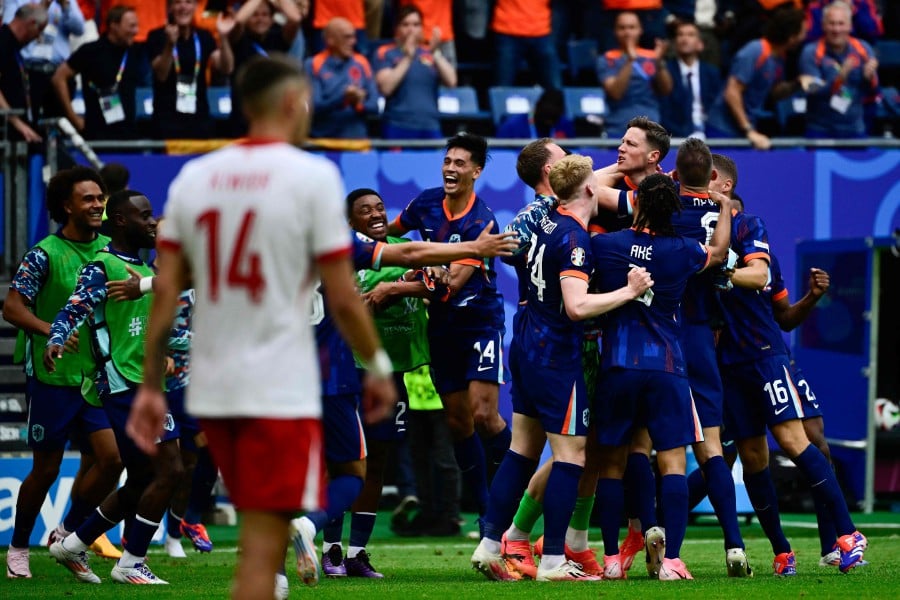 Netherlands' forward Wout Weghorst (R) celebrates scoring his team's second goal during the UEFA Euro 2024 Group D football match between Poland and the Netherlands at the Volksparkstadion in Hamburg. - AFP PIC