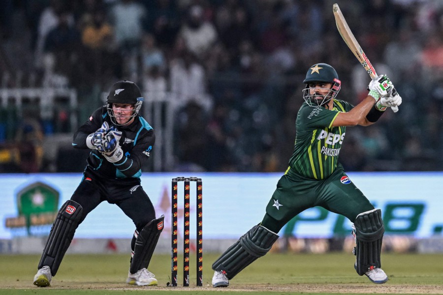 Pakistan's captain Babar Azam (R) plays a shot during the fifth and last Twenty20 international cricket match between Pakistan and New Zealand at the Gaddafi Cricket Stadium in Lahore. - APF PIC