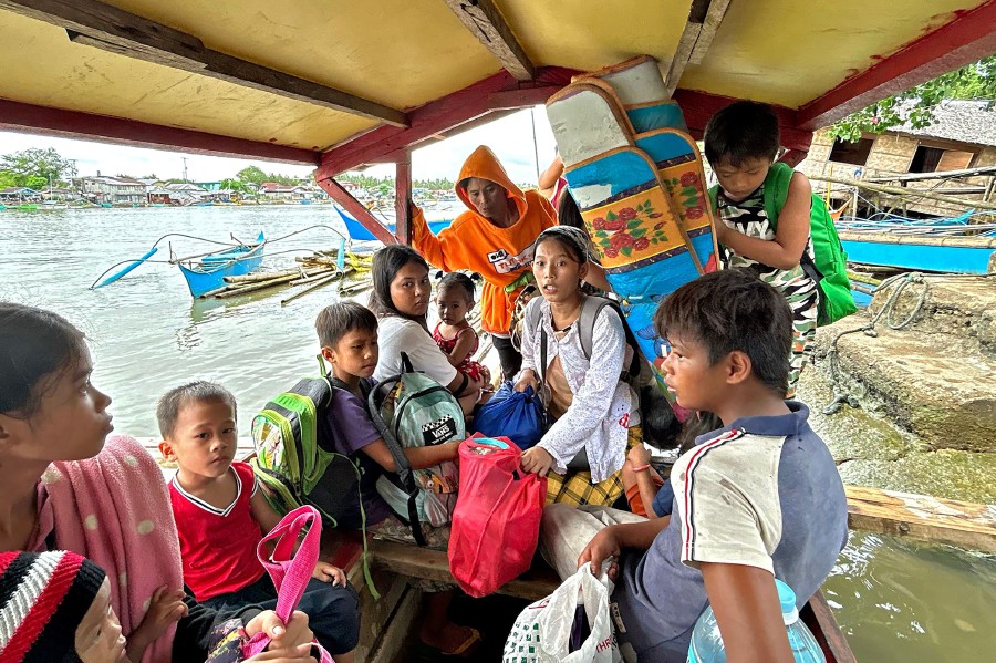  Earthquake-affected residents ride a boat as they evacuate from Hinatuan, Surigao del Sur province. - AFP PIC