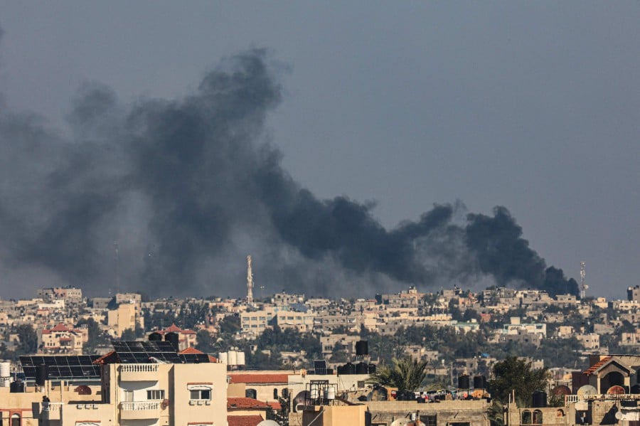 A picture taken from Rafah shows smoke billowing over Khan Yunis in the southern Gaza Strip. - AFP PIC
