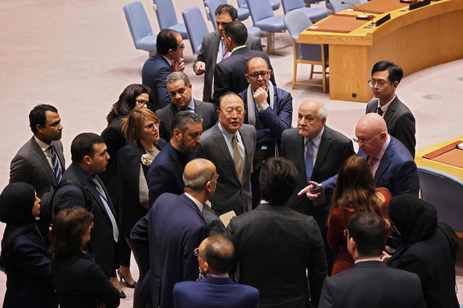  Palestinian Ambassador to the United Nations Riyad Mansour (3rd R) looks on as he speaks with members of the UN Security Council as they break during a meeting on the Israel-Hamas war at the United Nations headquarters on December 19, 2023 in New York City. - AFP PIC