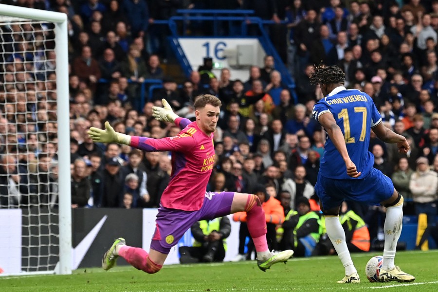 Chelsea's midfielder Carney Chukwuemeka shoots to score their third goal past Leicester City's goalkeeper Jakub Stolarczyk during the English FA Cup quarterf inal football match at Stamford Bridge in London. - AFP PIC