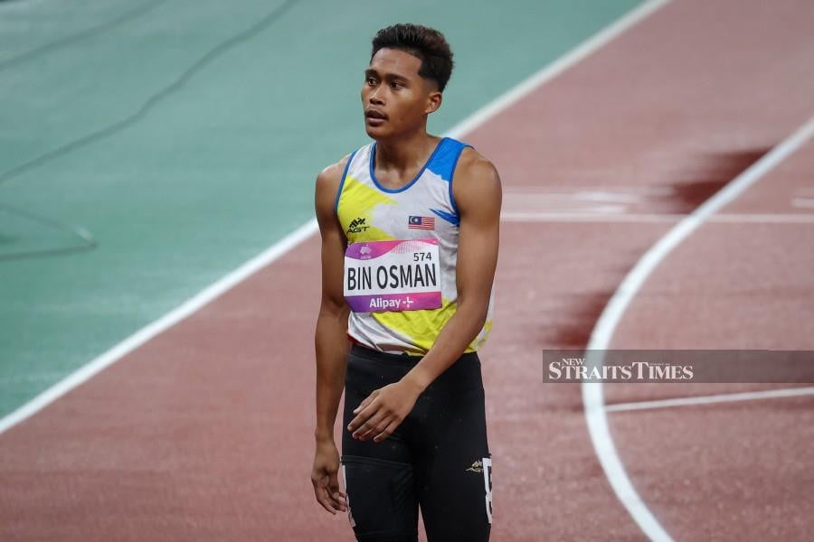Umar Osman react after the men’s 400m race in Hangzhou on Sept 29. -NSTP/ASYRAF HAMZAH