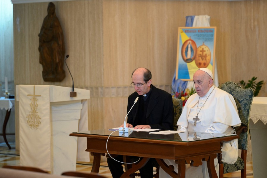 Pope Francis (R) reciting the Angelus Prayer flanked by Mons. Paolo Braida (L) in his residence at the Vatican. - AFP PIC