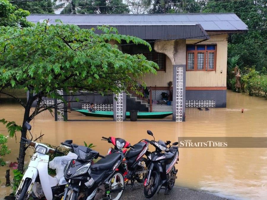 A house in Kuala Krai is inundated with floodwaters following rain. - NSTP/Sharifah Mahsinah Abdullah