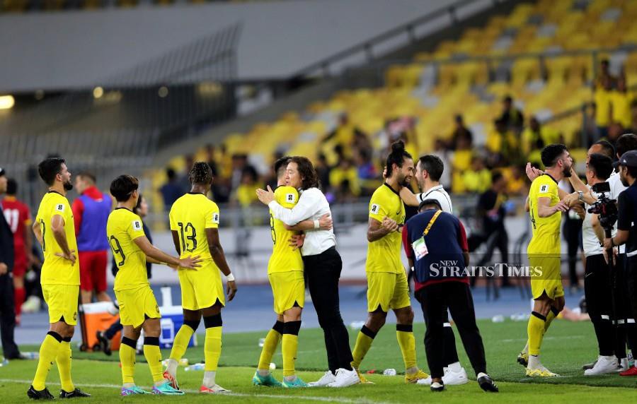 Kim Pan Gon embraces his players after beating Kyrgyzstan in a World Cup Group D qualifier at the National Stadium in Bukit Jalil. -NSTP/ASWADI ALIAS