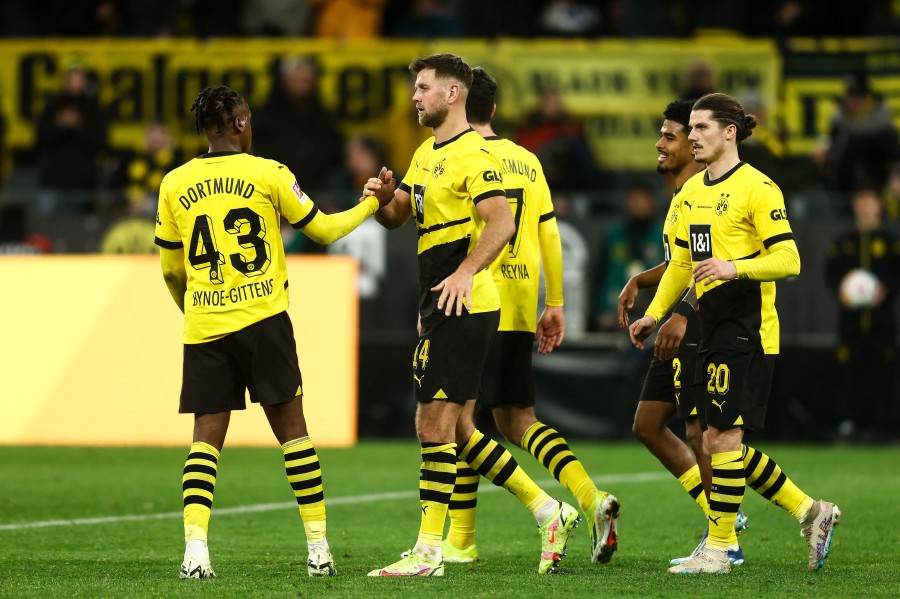 Dortmund's 4 Niclas Fuellkrug (C) celebrates scoring the 3-1 goal during the German first division Bundesliga football match between BVB Borussia Dortmund and VfL Bochum in Dortmund. - AFP PIC