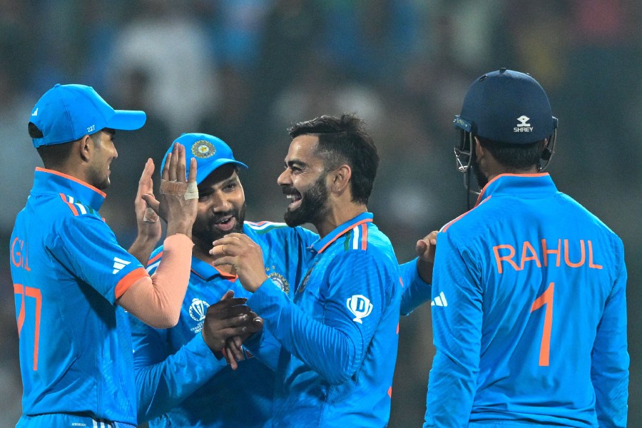 India's Virat Kohli (2R) celebrates with Shubman Gill (L), captain Rohit Sharma (2L) and KL Rahul after taking the wicket of Netherlands' captain Scott Edwards during the 2023 ICC Men's Cricket World Cup one-day international (ODI) match between India and Netherlands at the M. Chinnaswamy Stadium in Bengaluru. - AFP PIC
