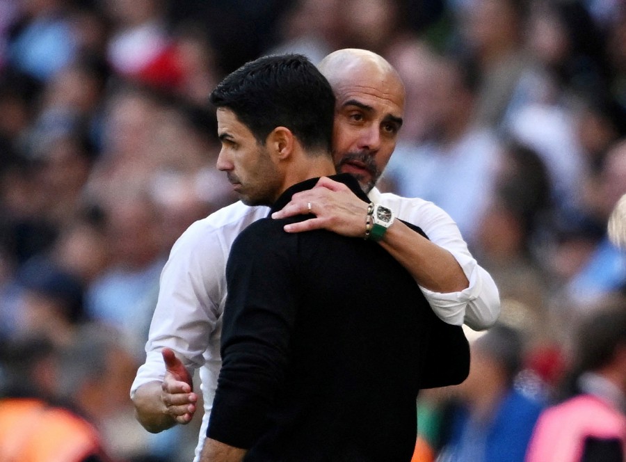 Manchester City manager Pep Guardiola with Arsenal manager Mikel Arteta.-REUTERS PIC