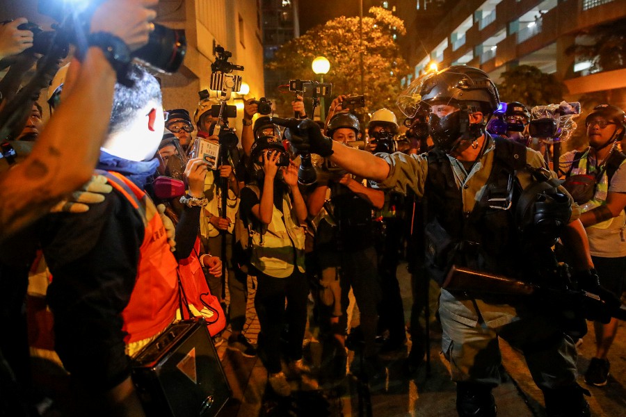  Police officers confront protestors at the Tseung Kwan O during an anti-government protest in Hong Kong. - EPA