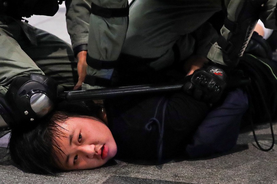 Hong Kong Police officers arrest a protester during Anti-government protest in Hong Kong. - EPA