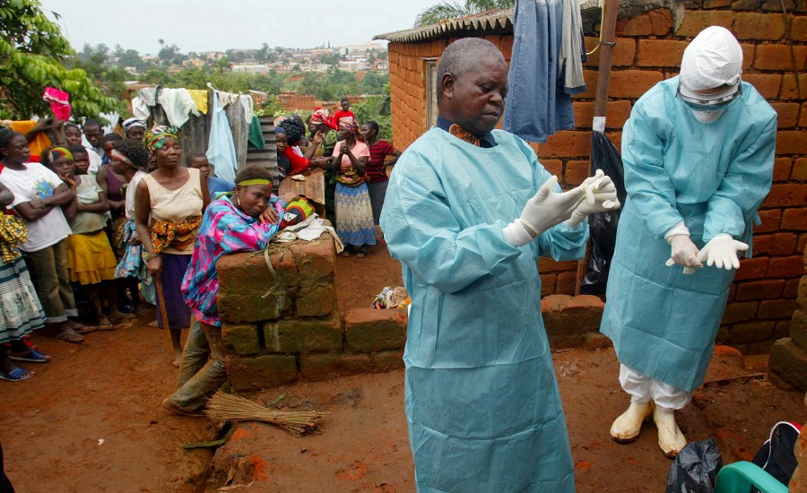  World Health Organisation (WHO) officials examine the home of a suspected Marburg virus victim in the northern Angolan town of Uige. - REUTERS PIC