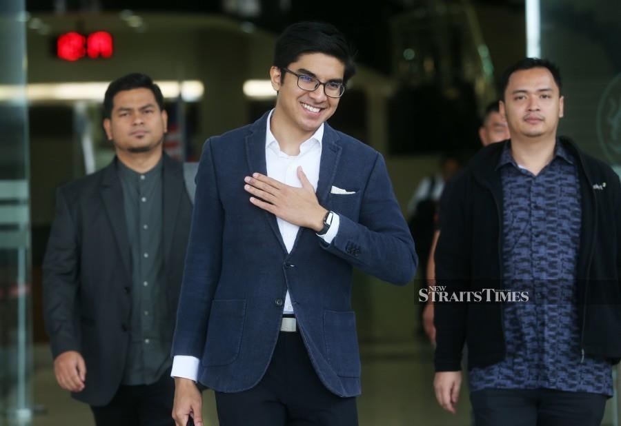 Syed Saddiq Syed Abdul Rahman  gestures as he arrives at the Kuala Lumpur Courts Complex ahead of the trial. -NSTP/ROHANIS SHUKRI
