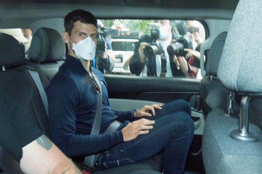 Serbian tennis player Novak Djokovic (C) departs from the Park Hotel government detention facility before attending a court hearing at his lawyers office in Melbourne, Australia, 16 January 2022. Novak Djokovic still faces uncertainty as to whether he can compete in the Australian Open, despite being announced in the tournament draw. - EPA pic