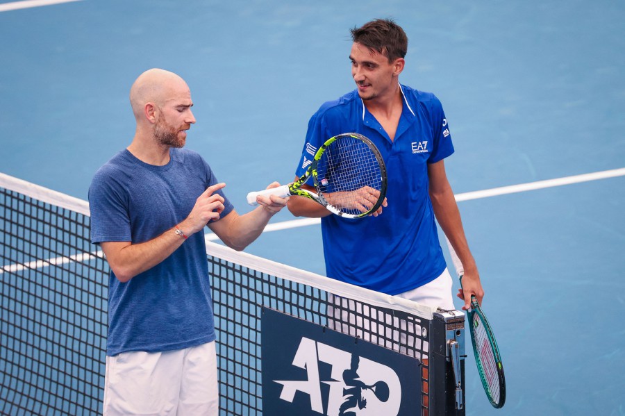 France's Adrian Mannarino (L) explains to Italy's Lorenzo Sonego how he caused a cut to his head after winning their men's singles match at the United Cup mixed tennis teams event on Ken Rosewall Arena in Sydney. - AFP PIC