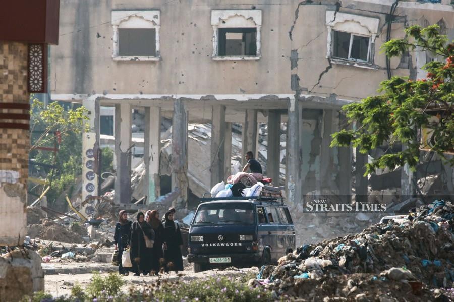 Displaced Palestinian civilians flee from the east of al-Bureij in the central Gaza Strip due to Israeli bombardment on the city. - AFP PIC