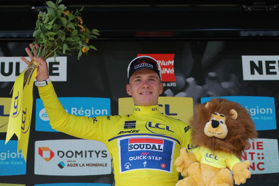 Team Soudal’s Remco Evenepoel wearing the overall leader’s yellow jersey celebrates on the podium after winning the fourth stage of the 76th edition of the Criterium du Dauphine, a 34,4km individual time trial between Saint-Germain-Laval and Neulise, central France, on Wednesday. - AFP PIC