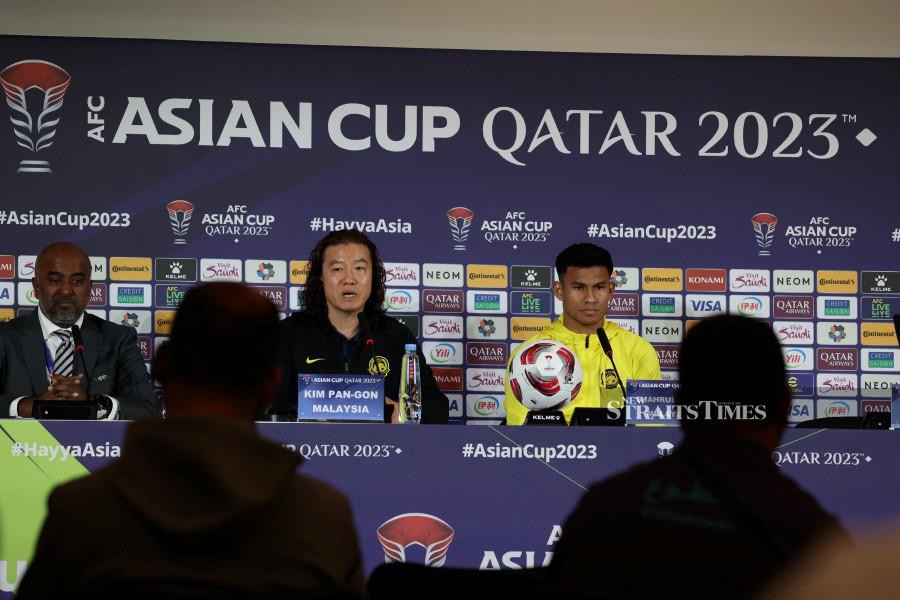 National coach Kim Pan Gon (centre) with Shahrul Saad (right) speaking to reporters during a press conference in Doha. -NSTP/HAIRUL ANUAR RAHIM.