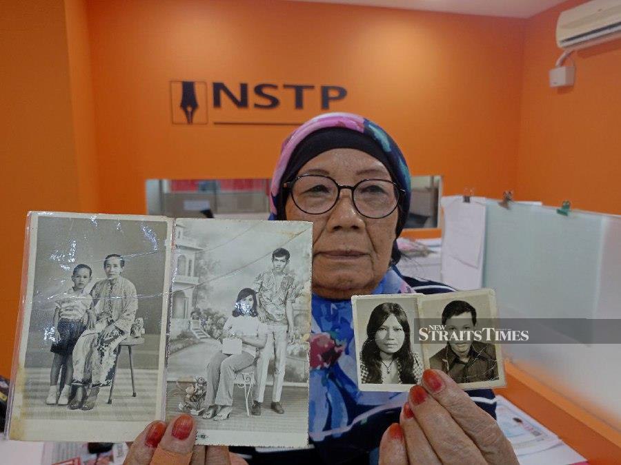 Che’ah Awang showing pictures of her son Muhammad Zain Salleh and daughter during an interview at NSTP Ipoh branch in Ipoh. -NSTP/MUHAMAD LOKMAN KHAIRI.
