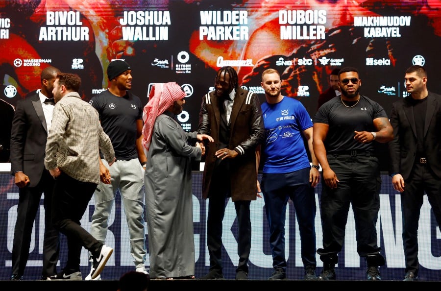 Deontay Wilder and Anthony Joshua with Turki Alalshikh during the press conference at the OVO Arena, London. - REUTERS PIC