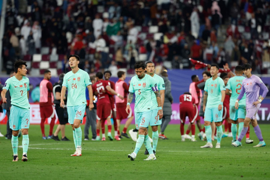 China's players walk on the pitch after the Qatar 2023 AFC Asian Cup Group A football match between Qatar and China at Khalifa International Stadium in Doha. - AFP PIC