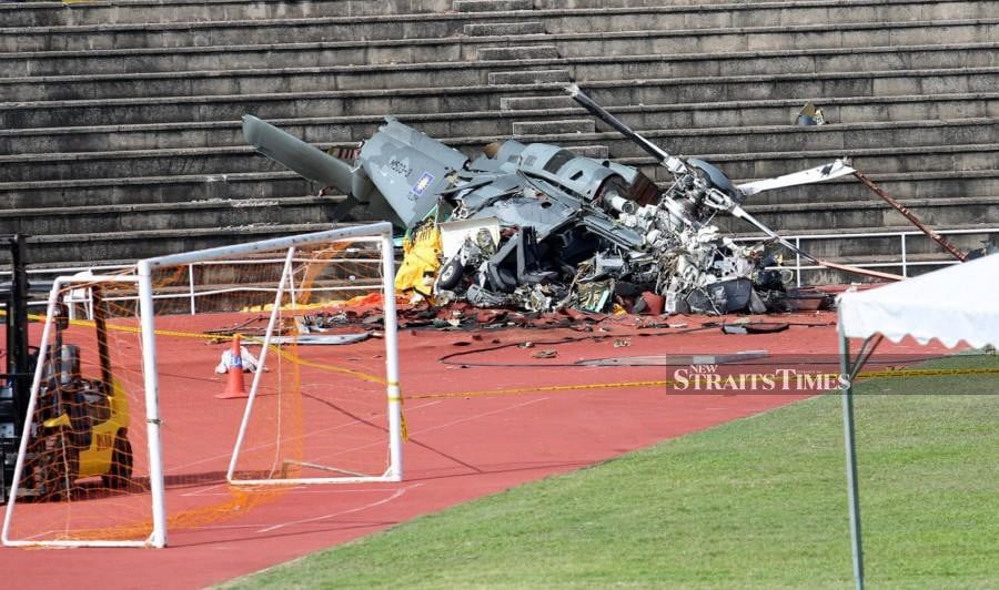 The wreckage of the M503-3 Maritime Operations Helicopter (HOM) is seen on the step of Navy Stadium in Lumut following the tragedy. - NSTP/L. MANIMARAN