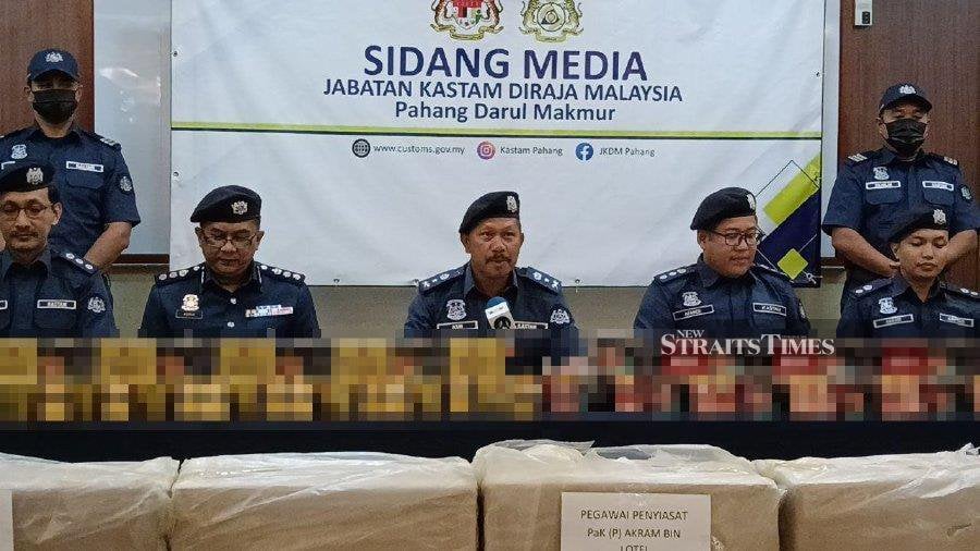 Pahang Customs Department director Mohd Asri Seman with the seized contraband cigarettes, during a press conference at the department’s headquarters in Kuantan. - NSTP/Asrol Awang