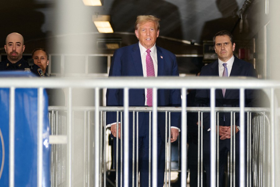 Former US President Donald Trump, flanked by lawyer Todd Blanche (R), speaks to the media after leaving the courtroom for the day during his trial for allegedly covering up hush money payments linked to extramarital affairs, at Manhattan Criminal Court in New York City. - AFP PIC