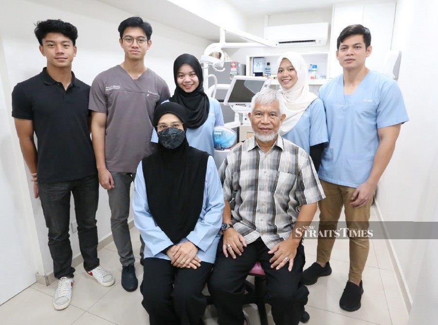 Dr Nor Azlina Mohd Amin with her family members at their dental clinic in Kuala Lumpur. - NSTP/SAIFULLIZAN TAMADI