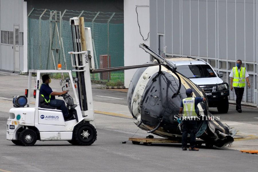 Airbus personnel removing the wreckage of Airbus H125 helicopter at Sultan Abdul Aziz Shah Airport. -NSTP/AIZUDDIN SAAD