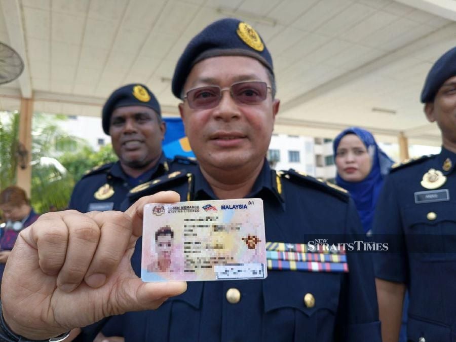 Kedah Road Transport Department deputy director Shahrul Azhar Mat Dali showing the suspected fake licence used by a Vietnamese man in Bukit Kayu Hitam. STR/ZULIATY ZULKIFFLI