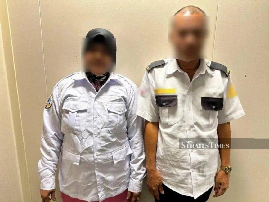 A Filipino couple using fake identity cards to work for over 10 years were nabbed in an operation in Kota Damansara, here, yesterday. - pic courtesy of NRD
