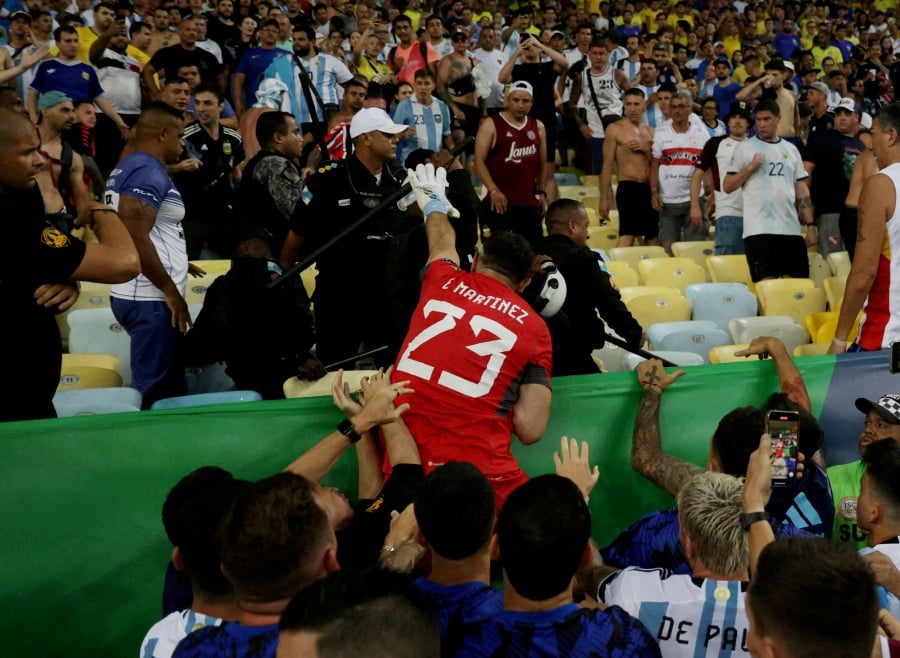World Cup - South American Qualifiers - Brazil v Argentina - Estadio Maracana, Rio de Janeiro, Brazil - November 21, 2023Argentina's Emiliano Martinez and teammates react as fans clash with security staff in the stands causing a delay to the start of the match. - Reuters pic