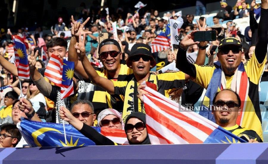 Malaysian fans cheer on during the Qatar 2023 AFC Asian Cup Group E football match between South Korea and Malaysia at Al-Janoub Stadium in al-Wakrah. -NSTP/HAIRUL ANUAR RAHIM