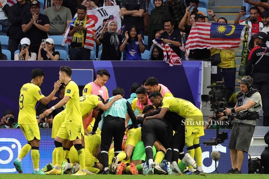 Malaysian players celebrate after their team's third goal during the Qatar 2023 AFC Asian Cup Group E football match between South Korea and Malaysia at Al-Janoub Stadium in al-Wakrah. - AFP PIC